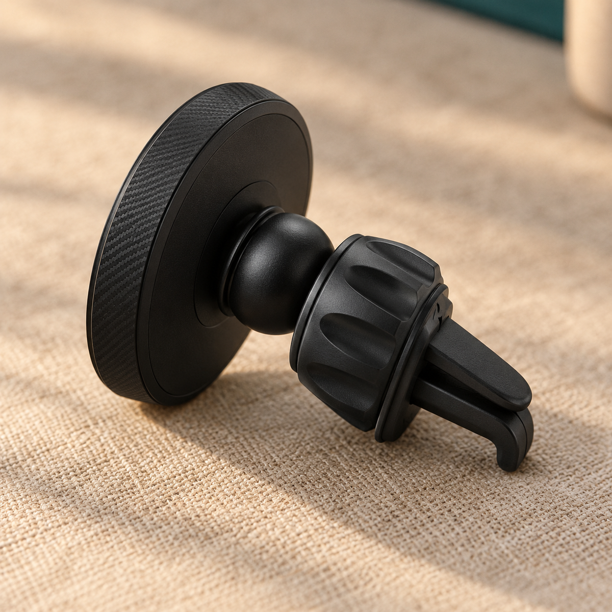 GripSway magnetic car phone holder seen from behind, showing the ball joint, adjustment collar and vent hook